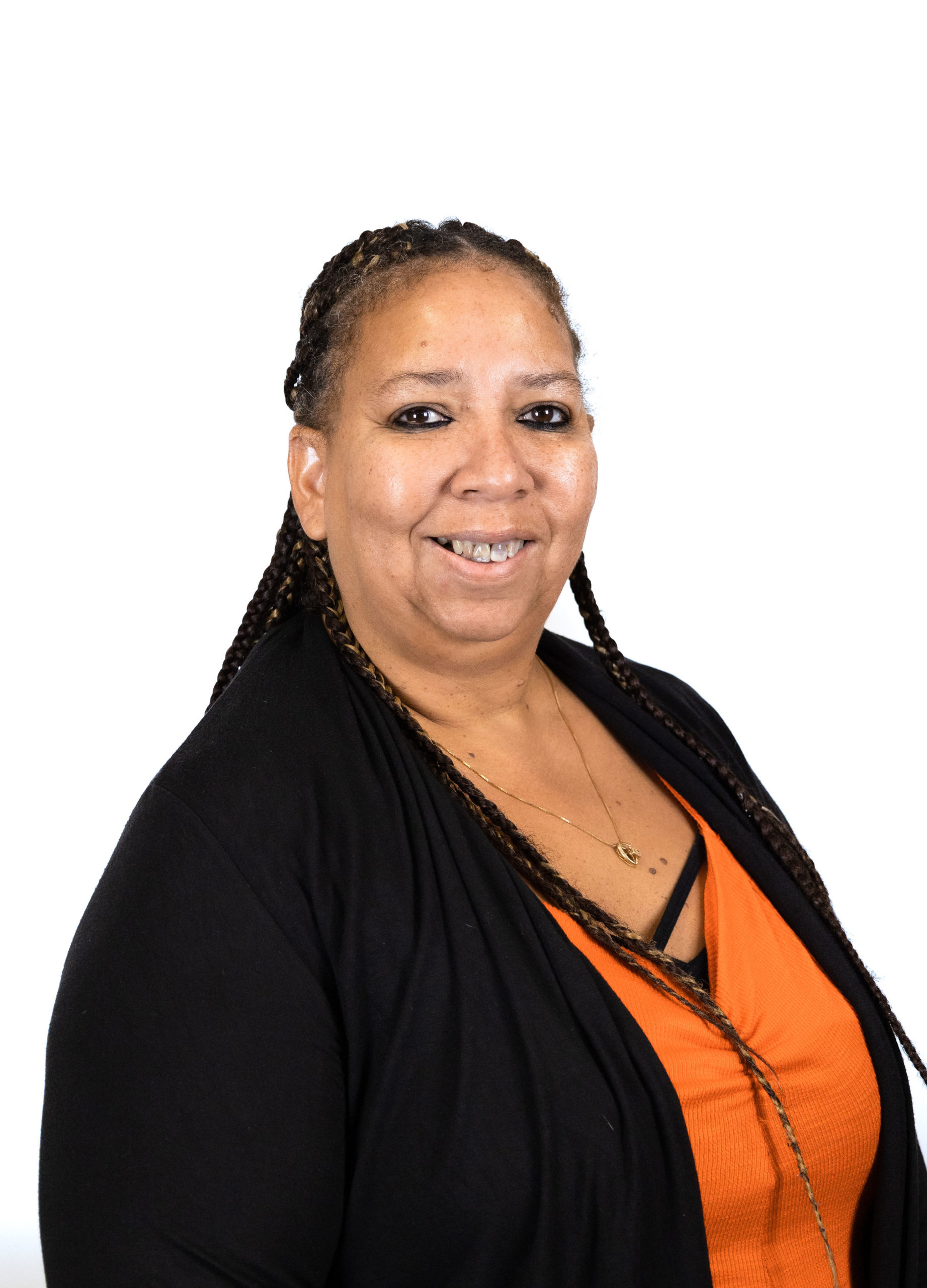 Heather Frigge 2022 Smiling woman wearing black jacket and orange top