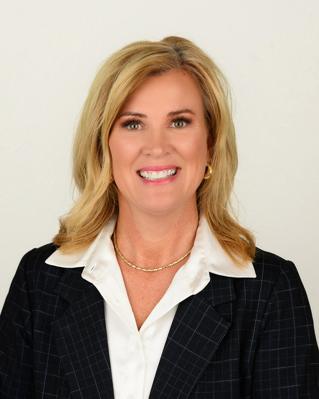 NWIA HS Jen Jansen Woman smiling with blonde hair, black jacket, white shirt