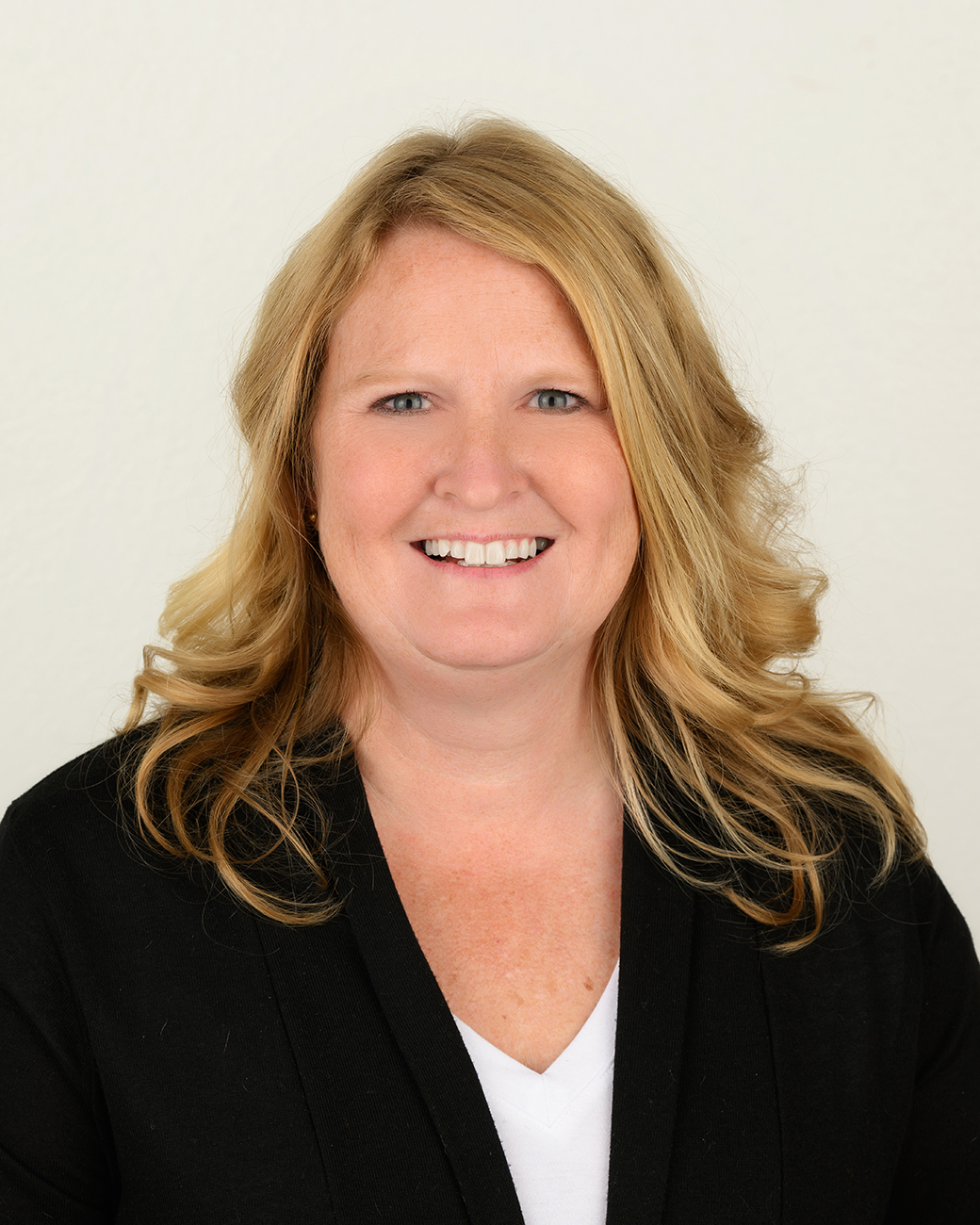 NWIA HS Katie Slater Woman smiling with black suit jacket and blonde hair