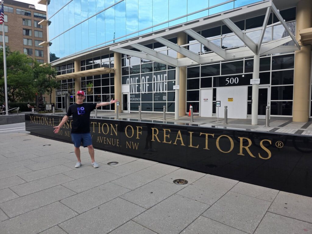 Chris Delfs stands outside the REALTOR building in Washington DC looking happy and excited